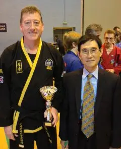 Mark Lloyd with Grand Master Kwang Jo Choi receiving trophy in UK Choi Kwang Do Showcase of Excellence